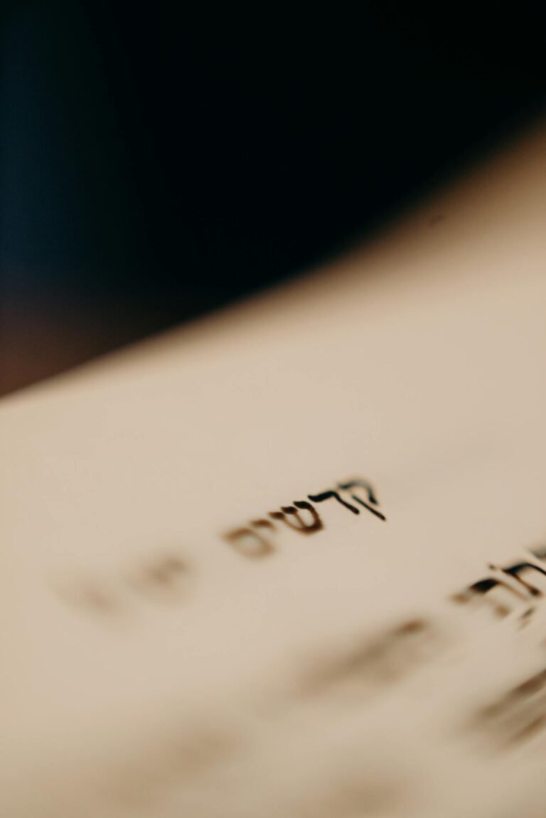 Detailed close-up of Hebrew text on a book page, evoking tradition and religious study.